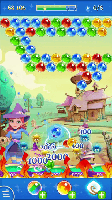 Gif shows the end of a level in Bubble Witch 2 Saga, with lots of bubbles falling into the cauldrons